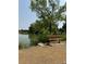 Park bench providing a scenic view of a lake and park grounds at 1829 S Lee St # C, Lakewood, CO 80232