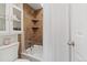 Clean bathroom showcasing a tiled shower with built-in shelves and a modern toilet at 1390 N Emerson St # 406, Denver, CO 80218