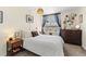 Cozy bedroom with a neutral color scheme, bedside tables, and a window with curtains at 1390 N Emerson St # 406, Denver, CO 80218