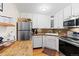 Well-lit kitchen featuring stainless steel appliances, white cabinetry, and granite countertops at 1390 N Emerson St # 406, Denver, CO 80218
