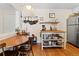 Bright kitchen with a wooden dining table, wooden floors, and a stainless steel refrigerator at 1390 N Emerson St # 406, Denver, CO 80218