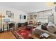 Cozy living room with hardwood floors, a large rug, a sofa, and a work/office area at 1390 N Emerson St # 406, Denver, CO 80218