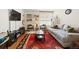 Bright living room featuring a neutral sofa, large window, and decorative area rug at 1390 N Emerson St # 406, Denver, CO 80218
