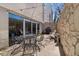 Outdoor patio area with seating, grill, stone wall, and a view of the building at 1390 N Emerson St # 406, Denver, CO 80218