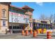 View of Ogden Theatre and surrounding businesses in the community with a clear blue sky at 1390 N Emerson St # 406, Denver, CO 80218