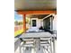 This patio has outdoor seating and a dining table with a modern design and views of the backyard at 4224 E Dickenson Pl, Denver, CO 80222