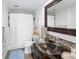 Bright bathroom featuring a glass vessel sink, mosaic backsplash, and shower with a white curtain at 790 N Washington St # 1210, Denver, CO 80203