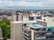 Exterior view showcasing rooftop pool amenity, with a backdrop of the city and Rocky Mountain range at 790 N Washington St # 1210, Denver, CO 80203