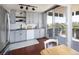 Stylish kitchen featuring sleek gray cabinetry, stainless steel appliances, and balcony access at 790 N Washington St # 1210, Denver, CO 80203