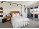 Main bedroom featuring a wood headboard, bedside tables, and a balcony at 790 N Washington St # 1210, Denver, CO 80203