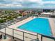 Beautiful rooftop pool with a clear glass safety barrier, featuring city and mountain views on the horizon at 790 N Washington St # 1210, Denver, CO 80203