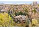 Stunning aerial view of the beautiful home nestled amongst mature trees in a peaceful neighborhood at 17 Polo Club Dr, Denver, CO 80209