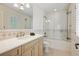 Bathroom showcasing a vanity, shower with glass door, and tiled walls at 17 Polo Club Dr, Denver, CO 80209