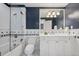 Charming bathroom featuring a tub/shower combo and white vanity at 17 Polo Club Dr, Denver, CO 80209