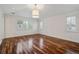 Airy bedroom with hardwood floors, white walls, and multiple windows with shutters at 17 Polo Club Dr, Denver, CO 80209