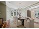 Formal dining room boasts large windows, elegant chandelier, and seating for eight at 17 Polo Club Dr, Denver, CO 80209