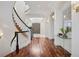 Grand foyer showcasing a curved staircase, hardwood floors, and elegant lighting at 17 Polo Club Dr, Denver, CO 80209