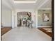 Grand foyer with a spiral staircase, beautiful tile floors, and elegant lighting fixtures at 17 Polo Club Dr, Denver, CO 80209