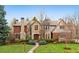 Charming stone and brick home with a well-manicured lawn and inviting walkway at 17 Polo Club Dr, Denver, CO 80209