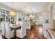 Expansive kitchen with white cabinetry, a central island, and dining area at 17 Polo Club Dr, Denver, CO 80209