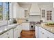 Gourmet kitchen features custom cabinets, high-end appliances, and elegant countertops at 17 Polo Club Dr, Denver, CO 80209