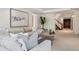Comfortable living room with a decorative painting, a glimpse of the staircase, and a modern coffee table at 17 Polo Club Dr, Denver, CO 80209