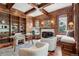 Spacious wood-paneled study featuring a fireplace, bookshelves, and comfortable seating at 17 Polo Club Dr, Denver, CO 80209