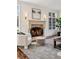Elegant living room featuring a stone fireplace and large windows for natural light at 17 Polo Club Dr, Denver, CO 80209