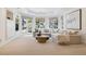 Cozy living room featuring a built-in entertainment center, a comfortable couch, and a view of the landscaped outdoors at 17 Polo Club Dr, Denver, CO 80209