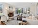 Inviting living room with a cozy fireplace, large windows, and stylish decor at 17 Polo Club Dr, Denver, CO 80209