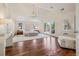 Spacious main bedroom with vaulted ceiling, large windows, and hardwood floors at 17 Polo Club Dr, Denver, CO 80209