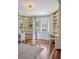 Bright home office with custom shelving, hardwood floors, and large windows at 17 Polo Club Dr, Denver, CO 80209