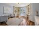 Stylish home office with custom built-in bookshelves, hardwood floors, and ample seating at 17 Polo Club Dr, Denver, CO 80209