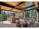 Outdoor kitchen area with a stone island, bar seating, a built-in grill, and comfortable lounge seating at 17 Polo Club Dr, Denver, CO 80209