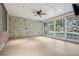 Bright sunroom with a stone accent wall, large sliding doors, and recessed lighting, offering a cozy retreat at 17 Polo Club Dr, Denver, CO 80209
