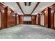 Home theater featuring wood paneling, sconce lighting, a projection screen, and a patterned carpet at 17 Polo Club Dr, Denver, CO 80209