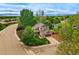 Aerial view of a charming two-story home with a well-manicured lawn nestled in a lush, green neighborhood at 301 Widgeon Ln, Longmont, CO 80503