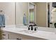 Bright bathroom features a sleek white vanity with modern black fixtures and a mirror at 301 Widgeon Ln, Longmont, CO 80503