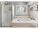 Relaxing bathroom with a soaking tub, a separate shower, and tile flooring at 301 Widgeon Ln, Longmont, CO 80503