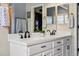 Modern bathroom with a double vanity, white countertops, and black fixtures at 301 Widgeon Ln, Longmont, CO 80503