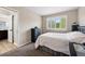 This bedroom features a neutral color palette and a sunny window with shutters at 301 Widgeon Ln, Longmont, CO 80503