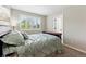 Inviting bedroom with a charming bed and a bright window with plantation shutters at 301 Widgeon Ln, Longmont, CO 80503