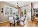 Bright dining area with hardwood floors, a glass-top table, and natural light from large windows at 301 Widgeon Ln, Longmont, CO 80503
