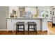 Kitchen island featuring white cabinets, granite countertops, and seating for two at 301 Widgeon Ln, Longmont, CO 80503