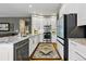 Modern kitchen featuring white cabinets, stainless steel appliances, and granite countertops at 301 Widgeon Ln, Longmont, CO 80503