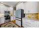 Modern kitchen featuring white cabinets, stainless steel appliances, and granite countertops at 301 Widgeon Ln, Longmont, CO 80503