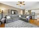 Spacious living room with hardwood floors, grey sectional, and an open floor plan to the kitchen at 301 Widgeon Ln, Longmont, CO 80503
