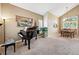 Elegant living room featuring a grand piano and formal dining set for entertaining at 301 Widgeon Ln, Longmont, CO 80503