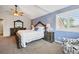 Comfortable main bedroom with a wooden bed frame, white bedding, and shuttered windows at 301 Widgeon Ln, Longmont, CO 80503