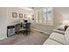 Functional office with a desk, computer setup, and a comfortable couch at 301 Widgeon Ln, Longmont, CO 80503